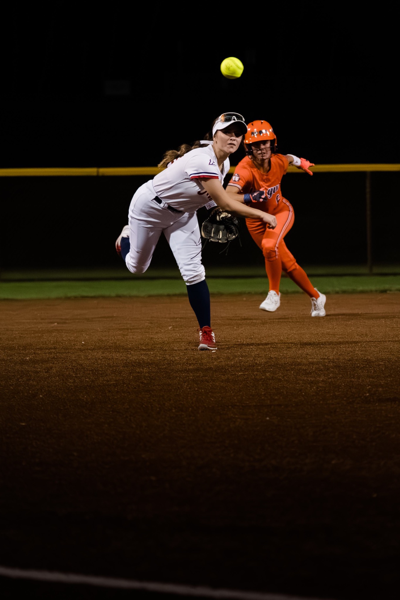 Mission infielder making a throw during a night game