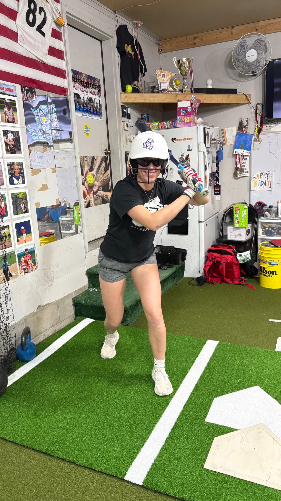 Softball athlete working on her stance during an indoor lesson